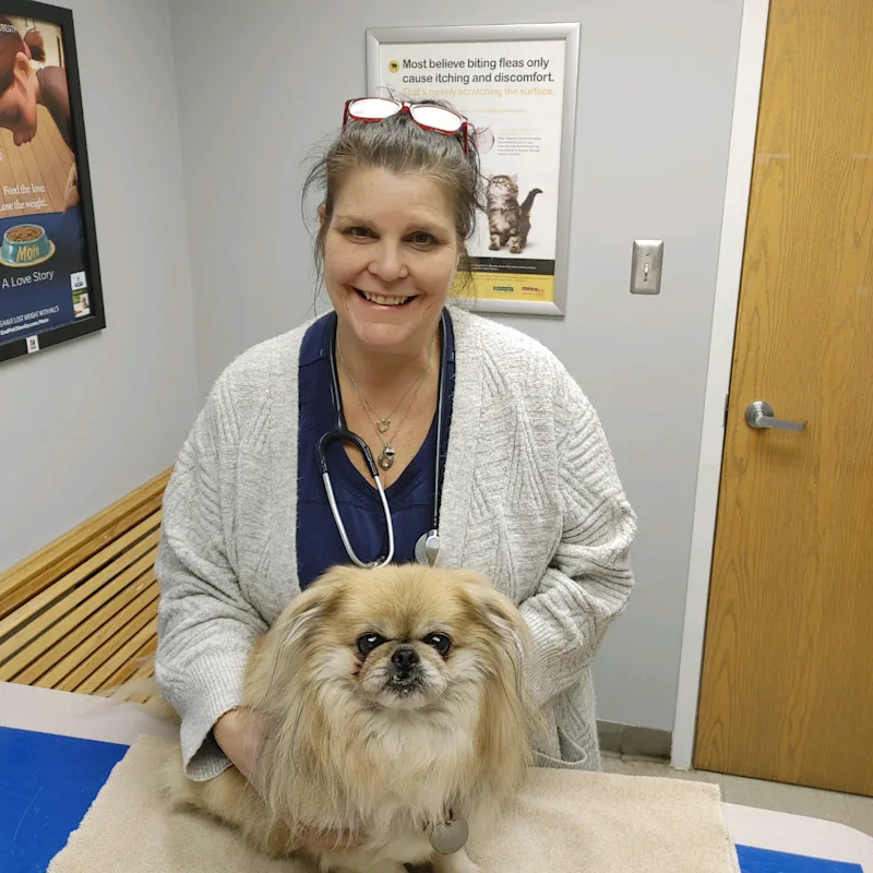 Dr. Kopilak Smiling with a fluffy dog Dr. Kopilak Smiling with a fluffy dog