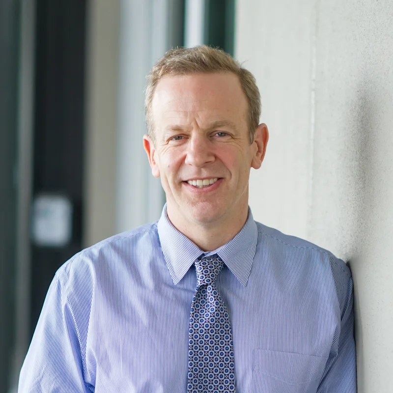 William Bush smiling in their suit. William Bush smiling in their suit.