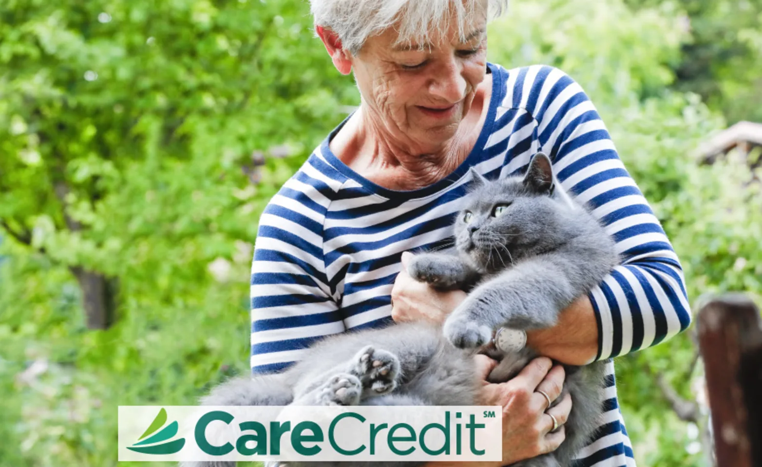 Old lady holding cat with the CareCredit logo