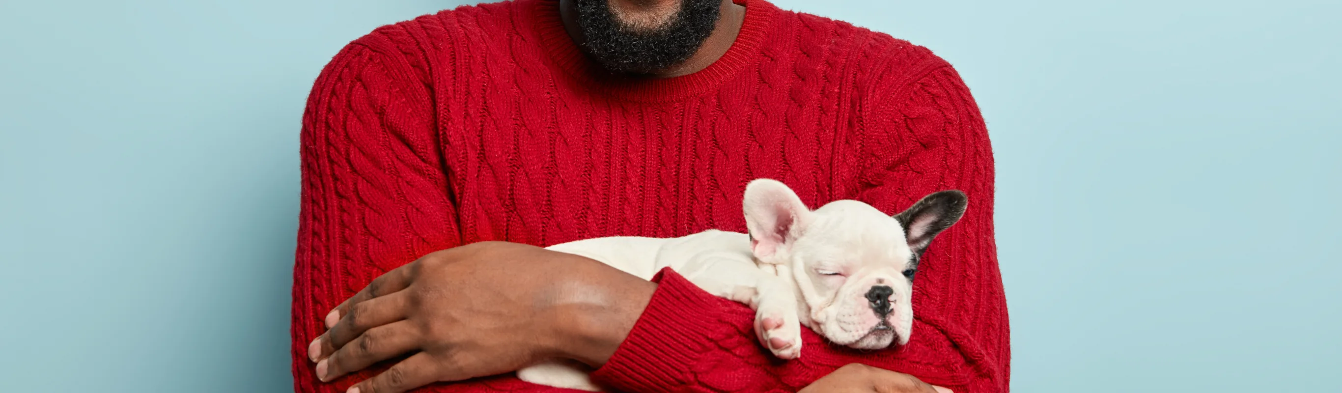 Red shirt on a man holding a dog