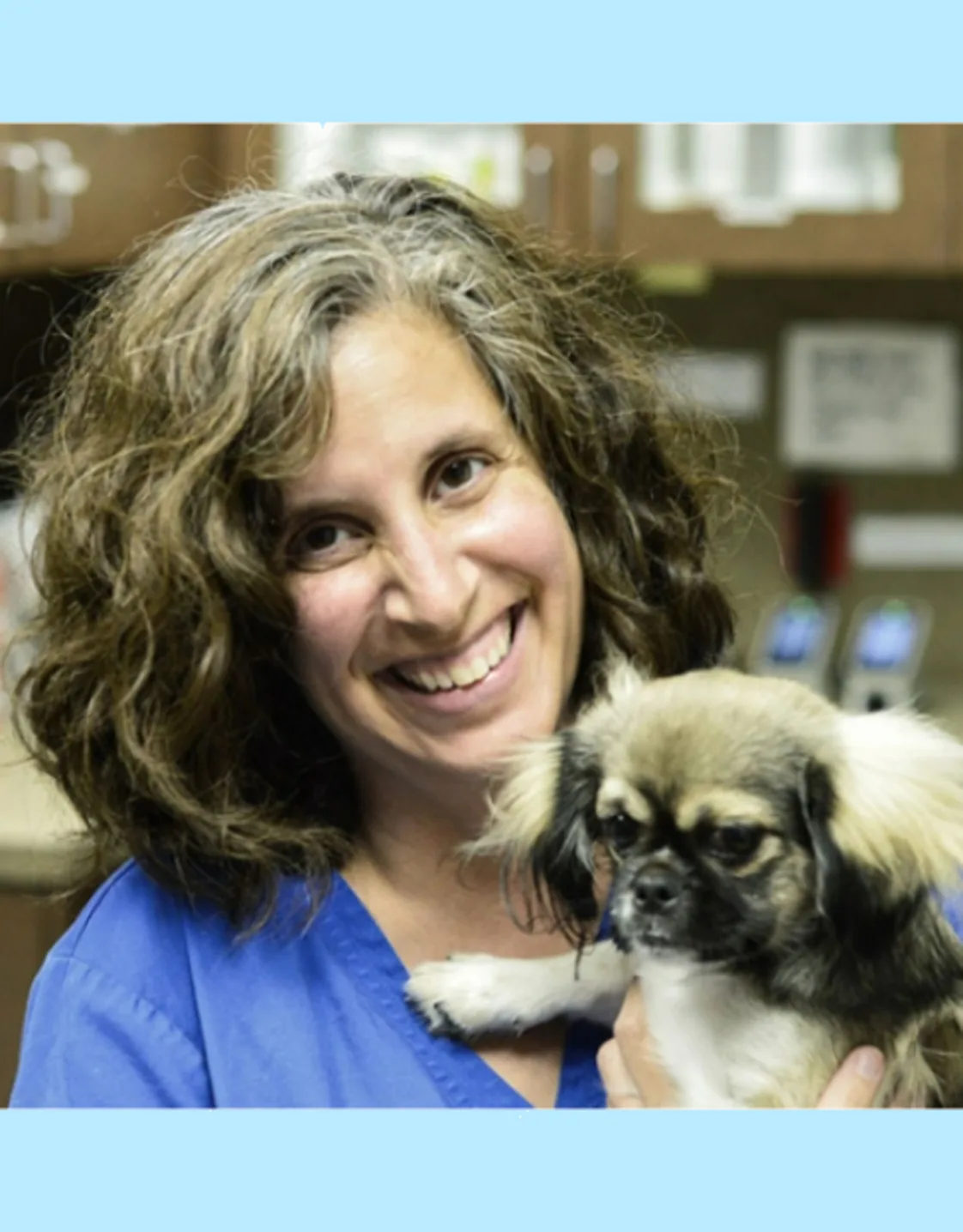Dr. Renee Bazan holding a small dog at The KAAWS Clinic Dr. Renee Bazan holding a small dog at The KAAWS Clinic