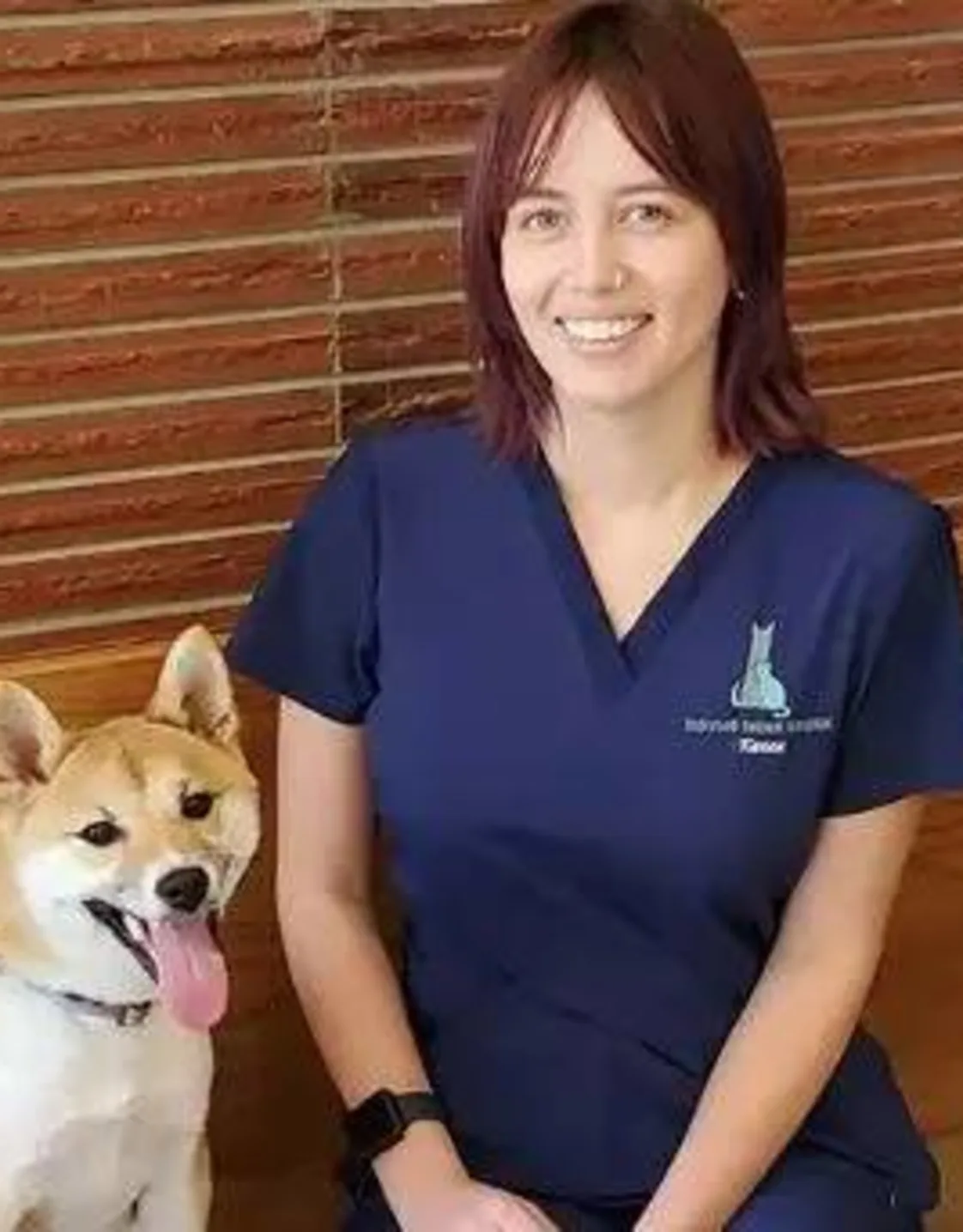 Karen smiling and sitting next to a dog. Karen smiling and sitting next to a dog.