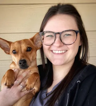 Maria Hastings holding a small brown dog Maria Hastings holding a small brown dog