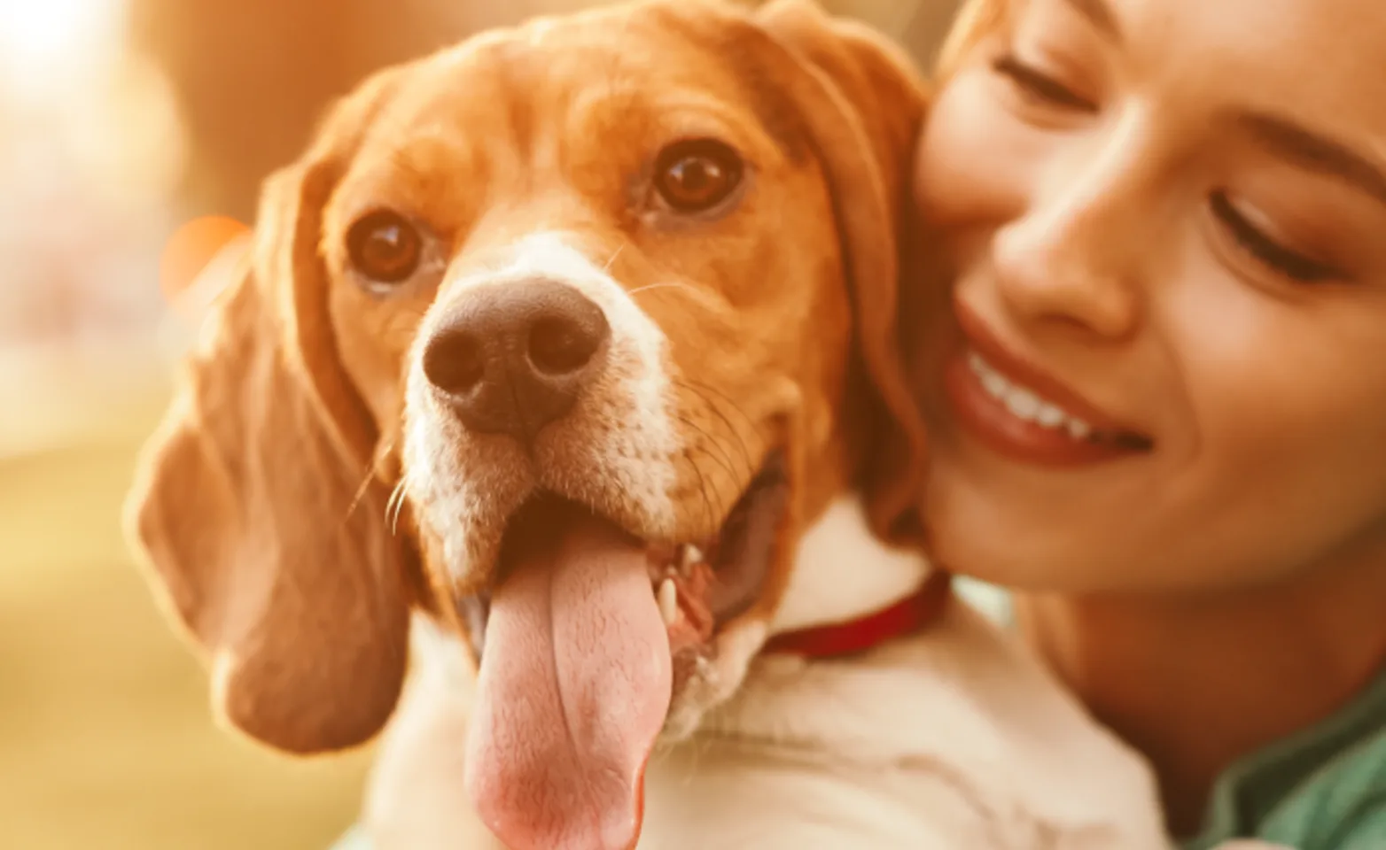 Girl holding dog with tongue out 
