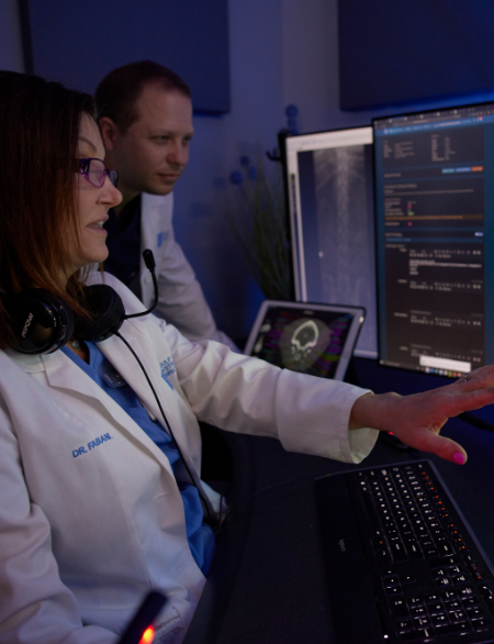 Vets looking at a monitor displaying radiograph images