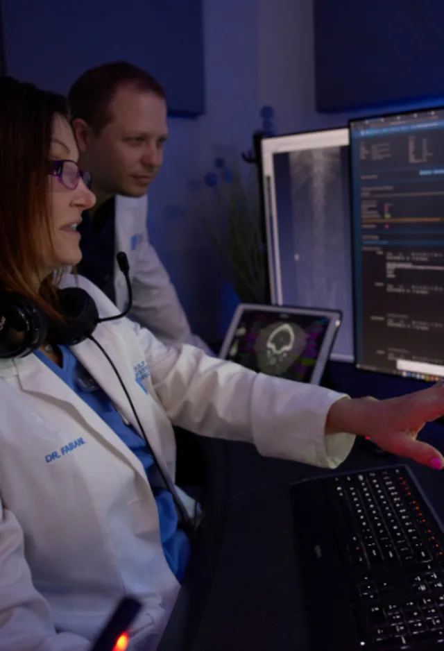 Vets looking at a monitor displaying radiograph images Vets looking at a monitor displaying radiograph images