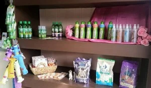 A shelf containing Clarksville Kennels retail products such as shampoos, treats, and pet toys