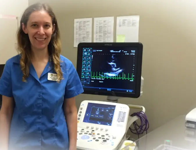 Veterinarian standing next to an ECG machine Veterinarian standing next to an ECG machine