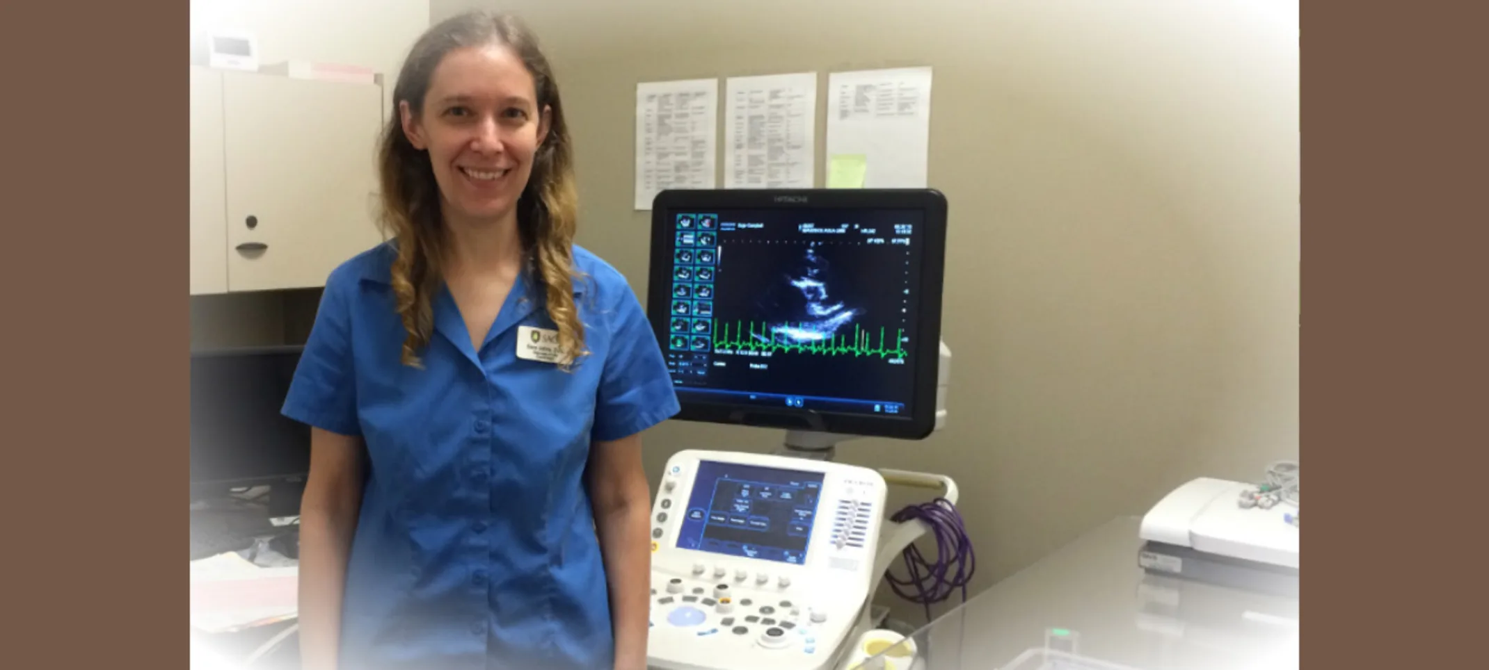 Veterinarian standing next to an ECG machine Veterinarian standing next to an ECG machine