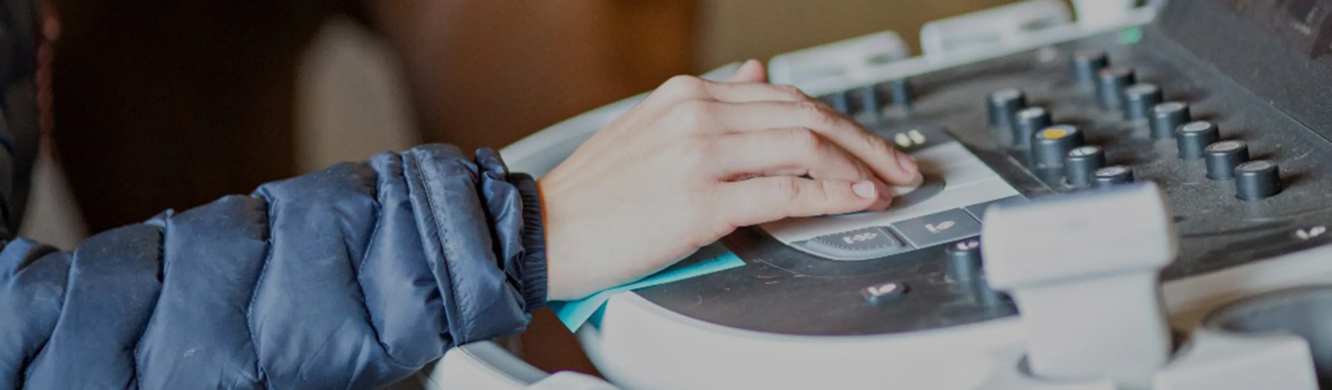 A veterinarian using an ultrasound machine with a horse in the background A veterinarian using an ultrasound machine with a horse in the background