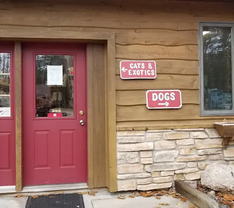 Signs indicating where patients should go if they are bringing in a cat/exotic animal or a dog at All Creatures Veterinary Clinic