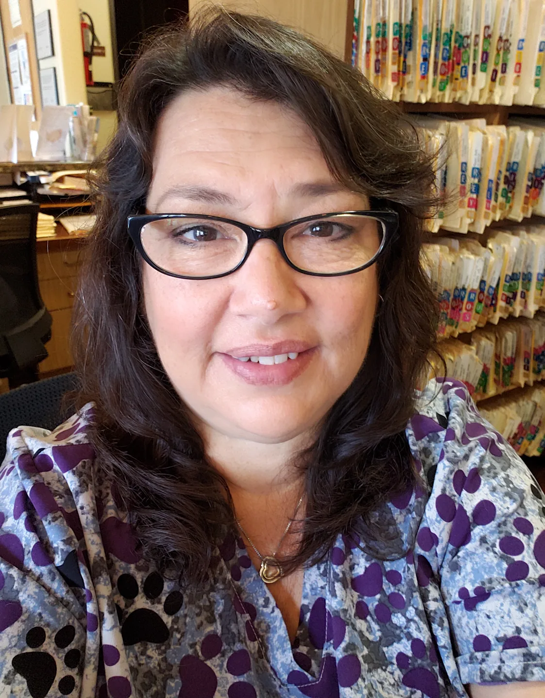 Tina's staff photo from Telegraph Canyon Animal Medical Center where she is sitting at her desk with patient folders behind her Tina's staff photo from Telegraph Canyon Animal Medical Center where she is sitting at her desk with patient folders behind her