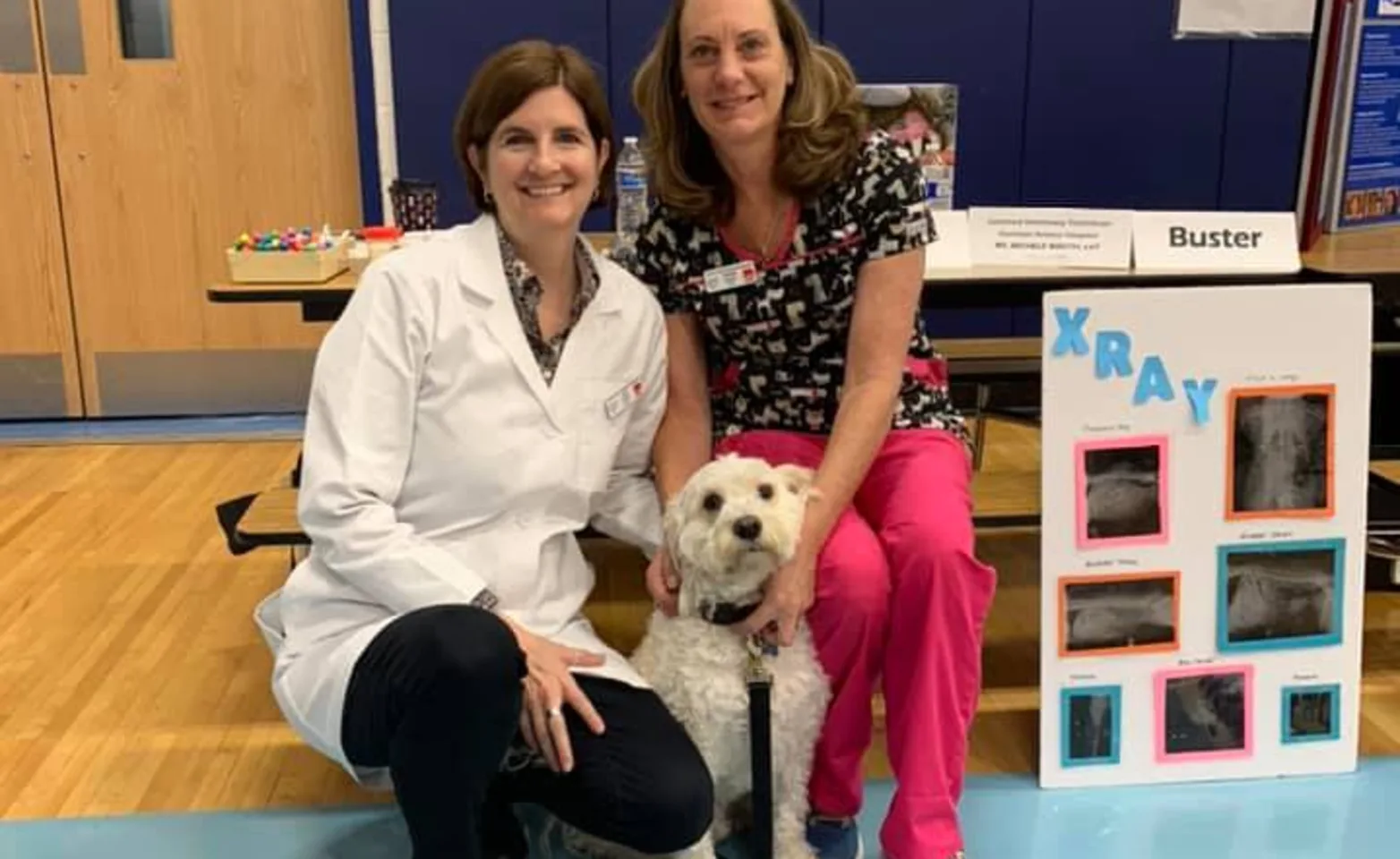 doctor posing in a middle school gym volunteering