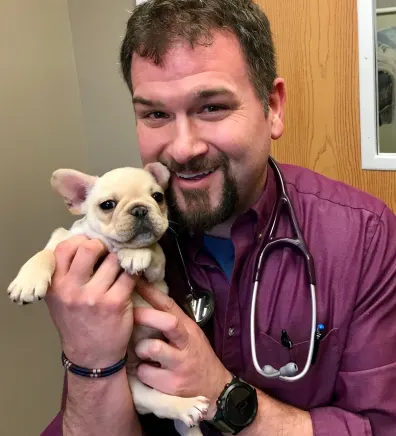Dr. Loren Noblitt holding a puppy