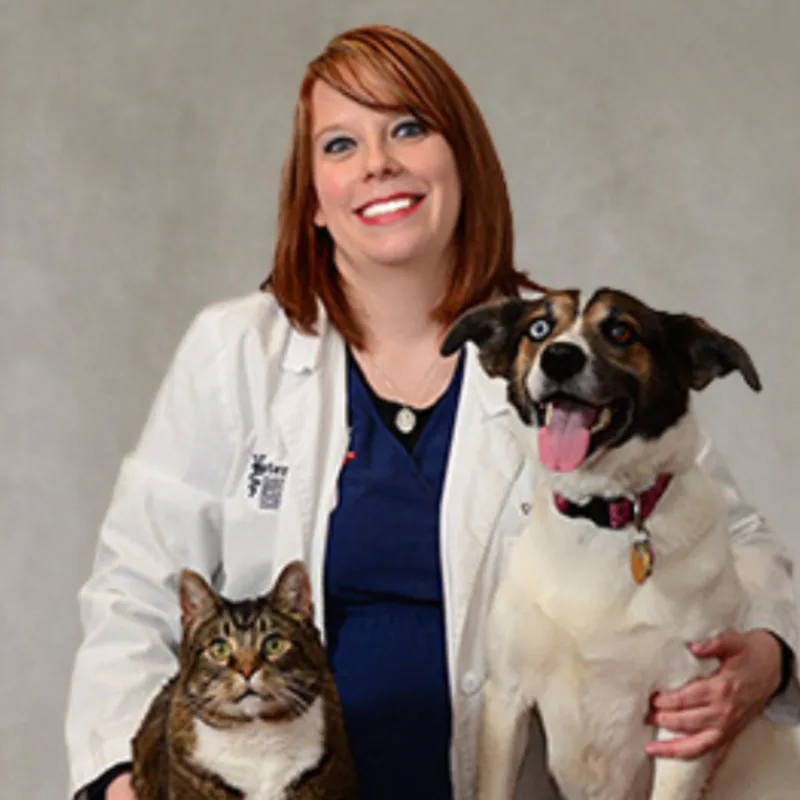 Dr. Ronnie Richardson sitting with a cat and dog Dr. Ronnie Richardson sitting with a cat and dog