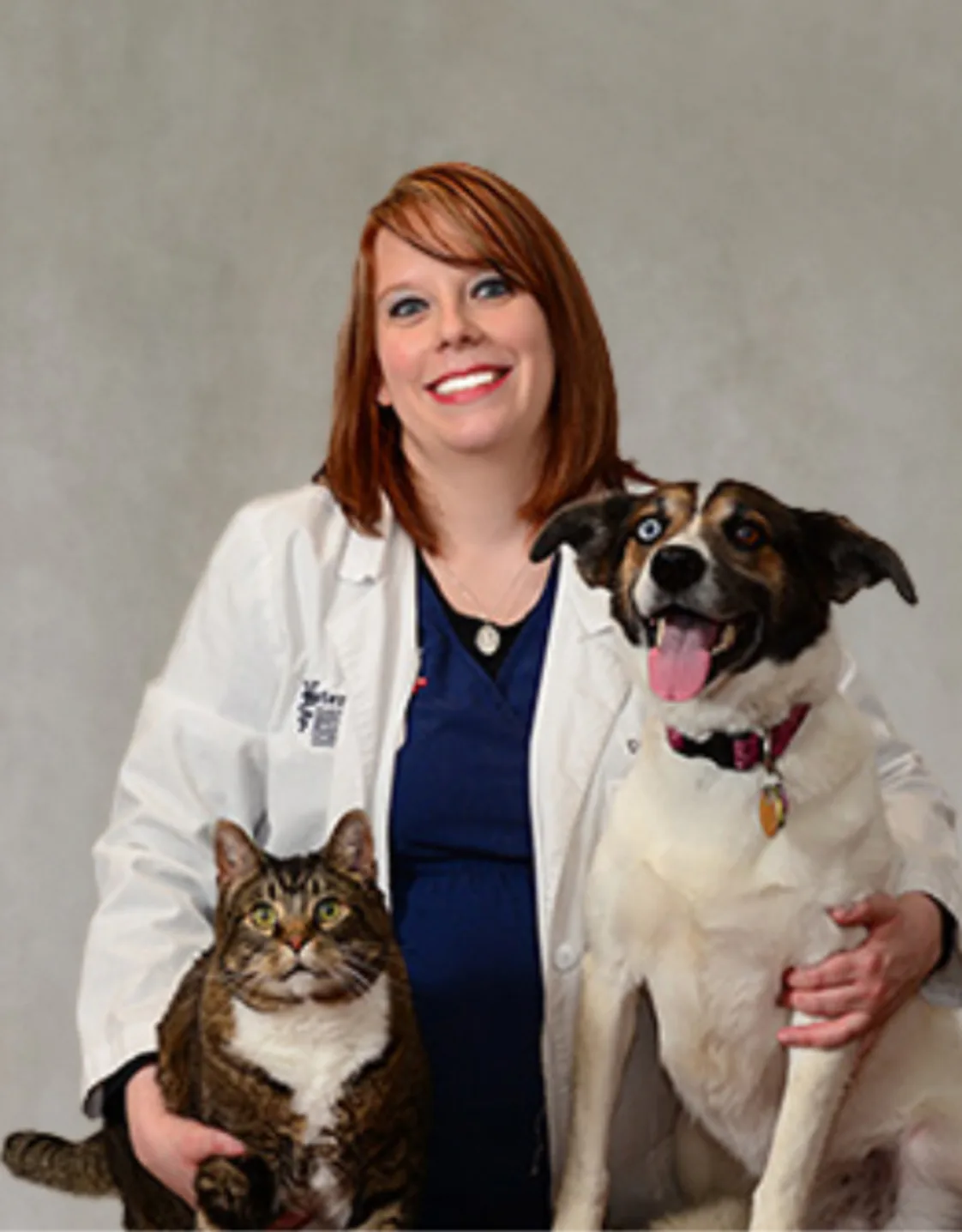 Dr. Ronnie Richardson sitting with a cat and dog Dr. Ronnie Richardson sitting with a cat and dog