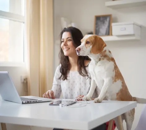 Woman with dog and laptop