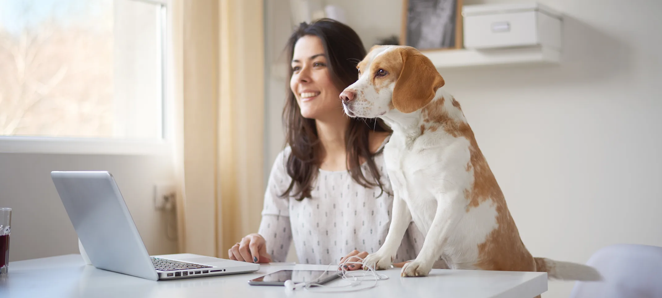 Woman with dog and laptop