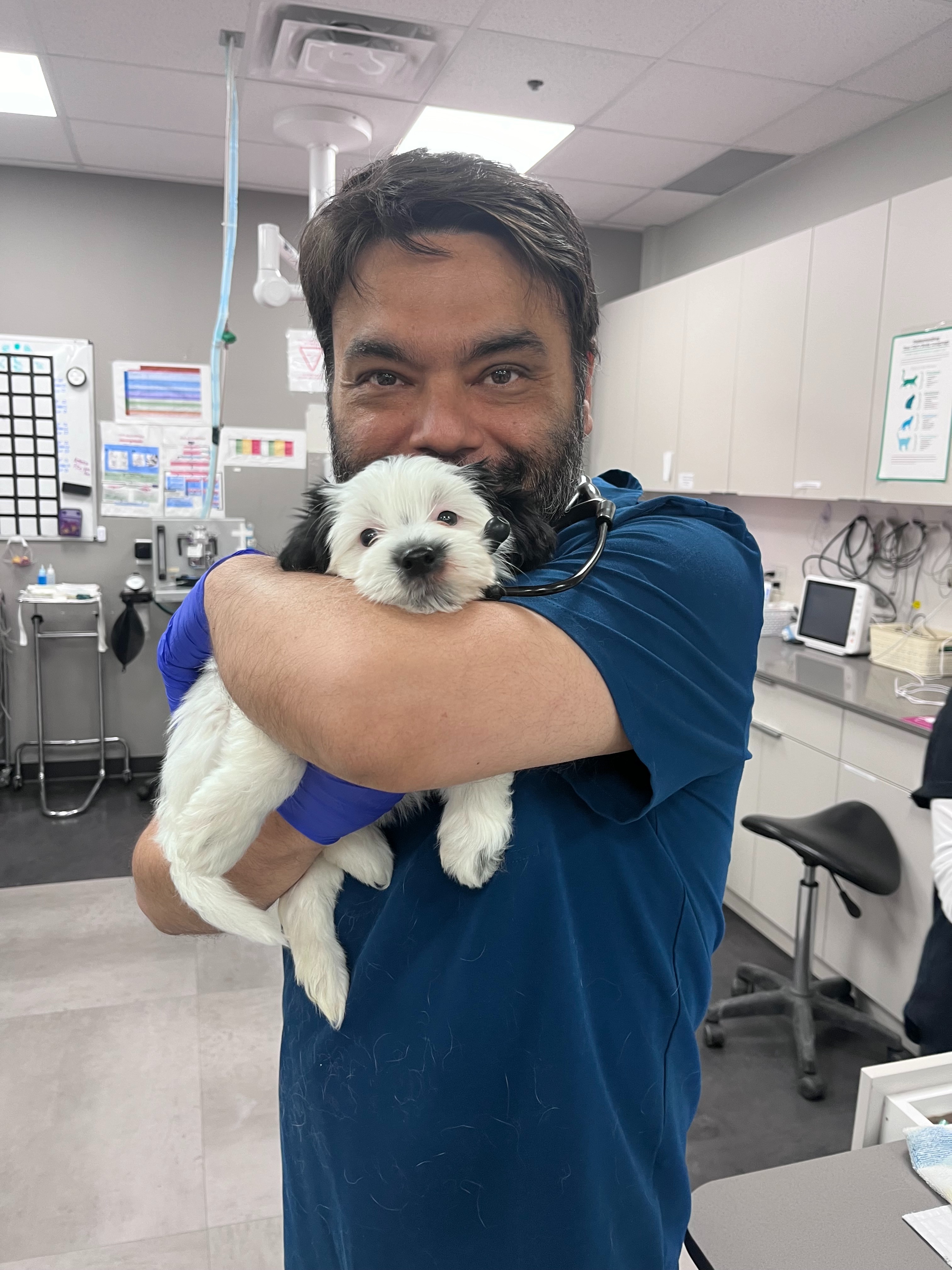 Dr. Jagsir is holding a white dog