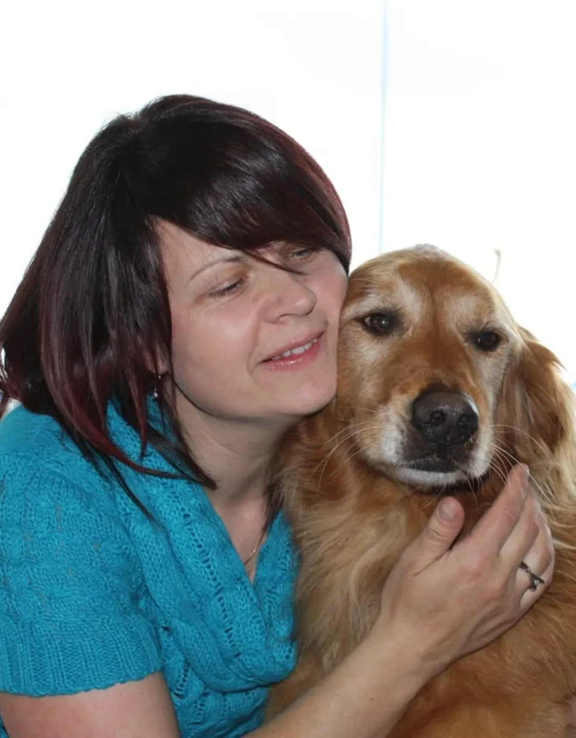Staff photo of Connie hugging a dog. Staff photo of Connie hugging a dog.