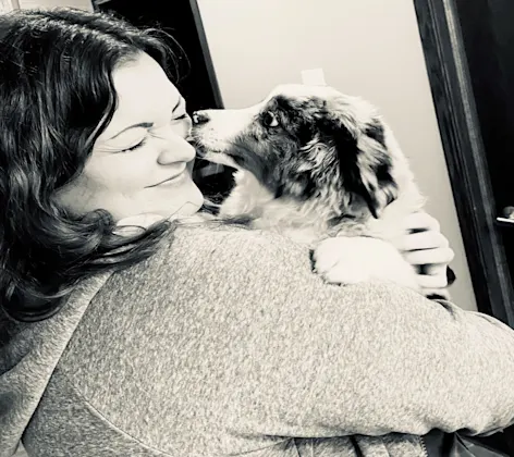 puppy licking staff member's face puppy licking staff member's face