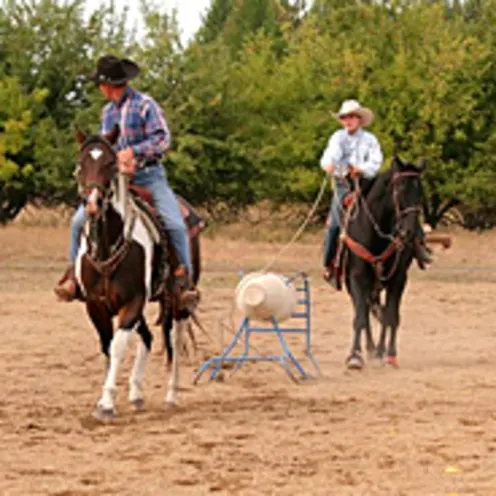 two people riding horses two people riding horses