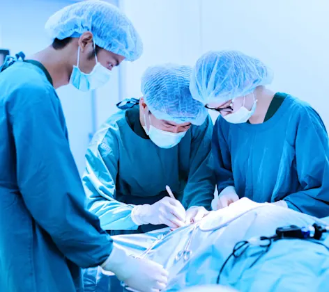 Surgeons operating on a patient Surgeons operating on a patient