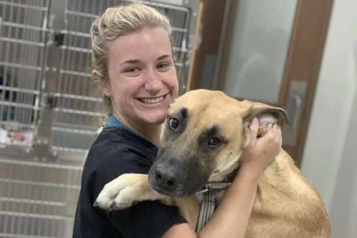 Staff Member Hugging a Dog