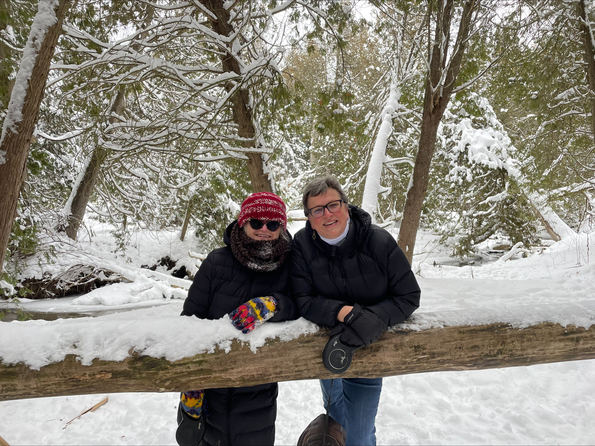 Sandra McBride smiling in the snow with a friend.