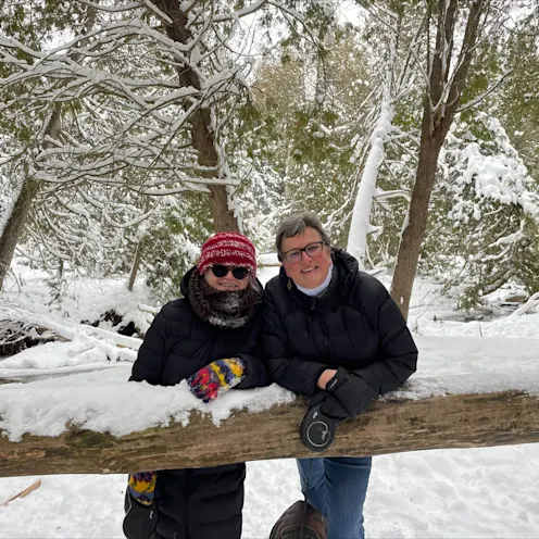 Sandra McBride smiling in the snow with a friend. Sandra McBride smiling in the snow with a friend.