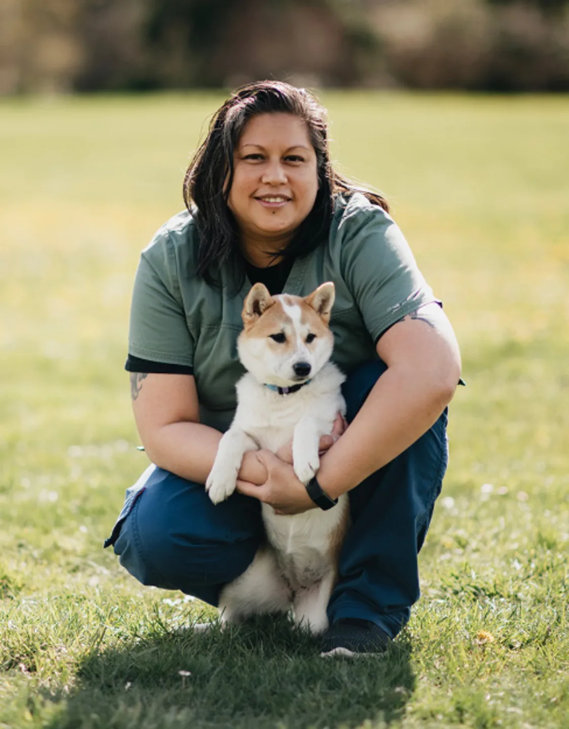 April Israel kneeling with a Shiba Inu dog April Israel kneeling with a Shiba Inu dog