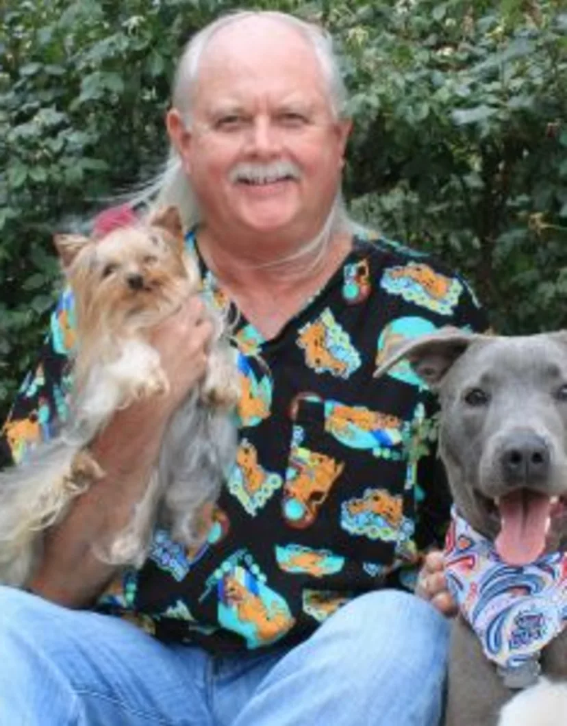 Dr. Barry Schmitt with two dogs at Stuebner Airline Veterinary Hospital
