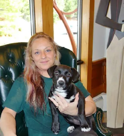 Diane holding a puppy. Diane holding a puppy.