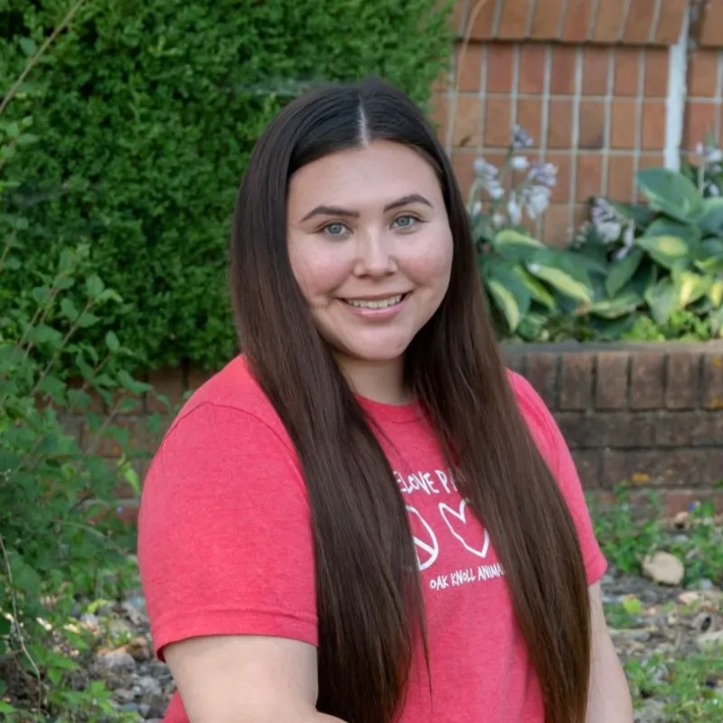 Shannon holding a dog with a dog next to her Shannon holding a dog with a dog next to her