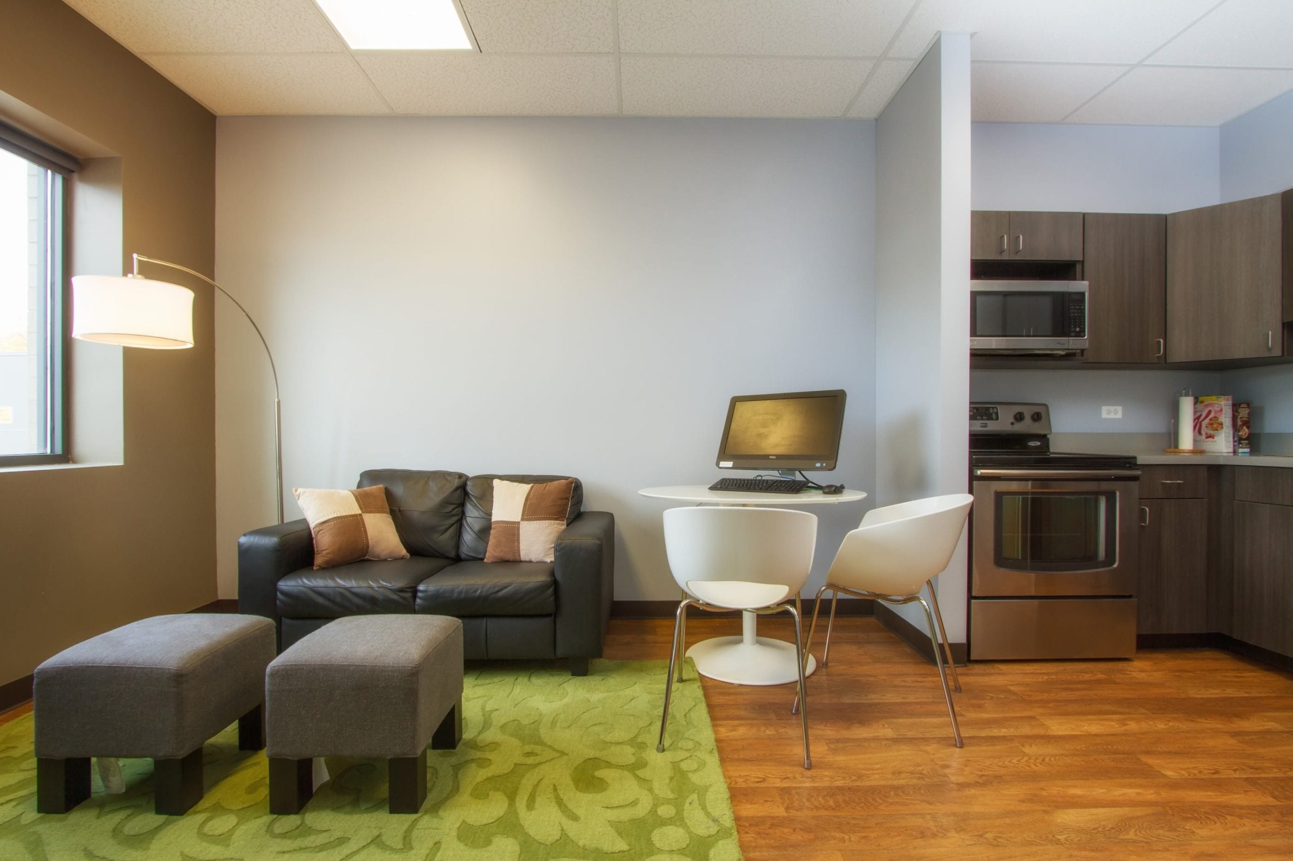 room with couch, table, and kitchenette