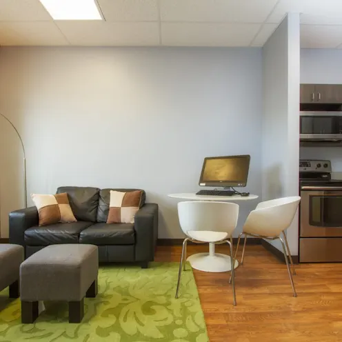 room with couch, table, and kitchenette room with couch, table, and kitchenette