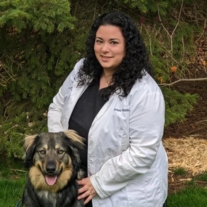 Dr. Stephanie Palumbo next to a dog outside Dr. Stephanie Palumbo next to a dog outside