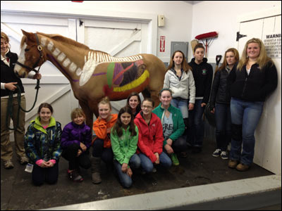 Children in Team Riders 4-H Club posing in front of horse
