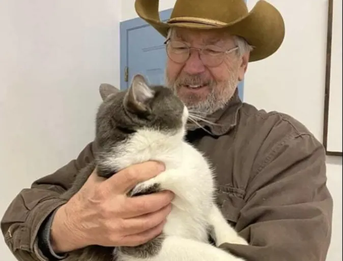 A man holding a cat