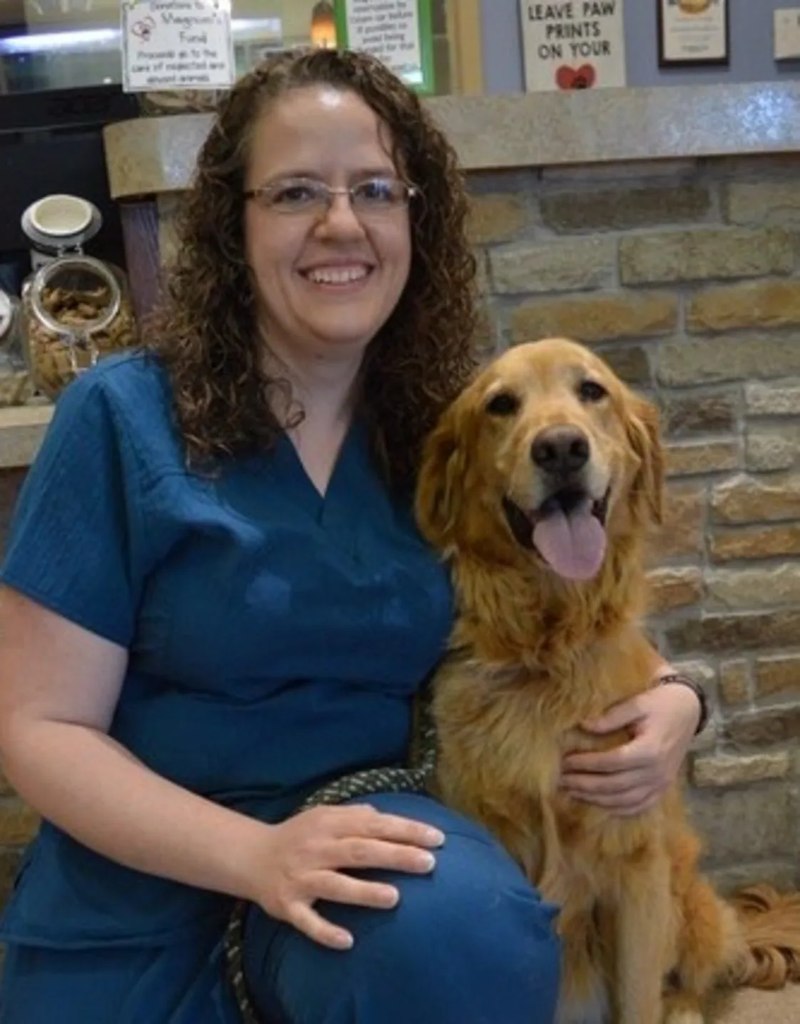 Anna kneeling down next to a golden retriever Anna kneeling down next to a golden retriever