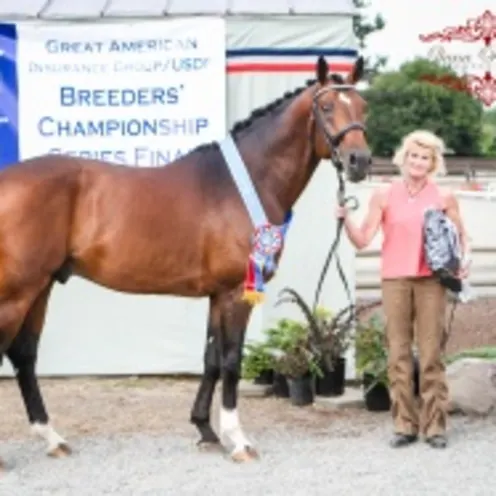 two people posing next to horse two people posing next to horse