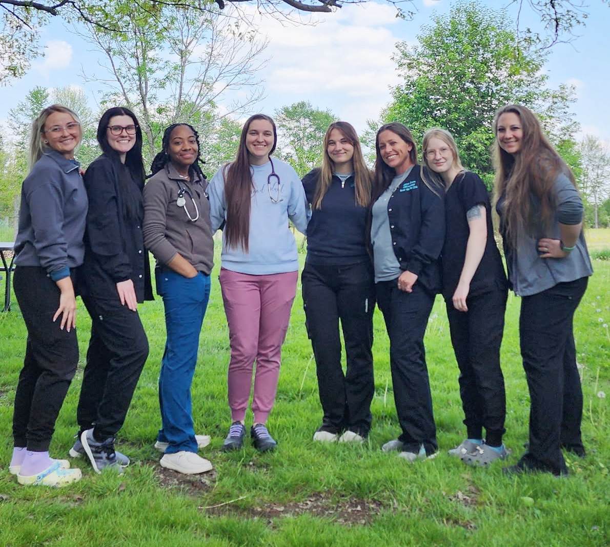 Picture of the  staff of Seven Hills Pet Clinic posing outside.