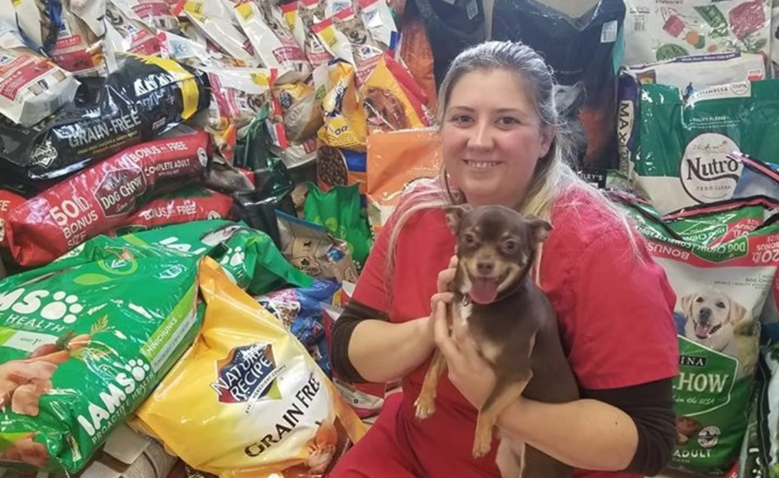 staff in front of food donations for pets