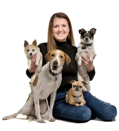 A portrait photo of Veterinary Assistant Susie with her four dogs A portrait photo of Veterinary Assistant Susie with her four dogs