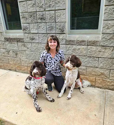 Heather, groomer at Animal Hospital of Towne Lake, with two dogs Heather, groomer at Animal Hospital of Towne Lake, with two dogs