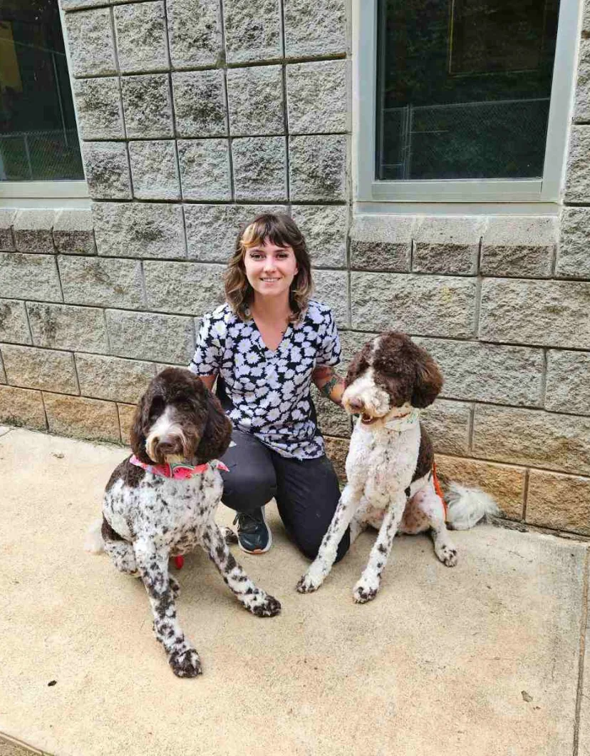 Heather, groomer at Animal Hospital of Towne Lake, with two dogs