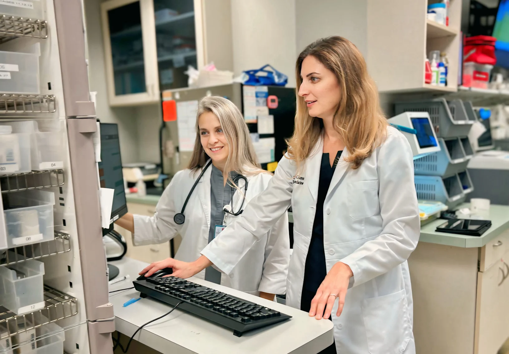 Dr. Guma standing in front of a computer. Dr. Guma standing in front of a computer.