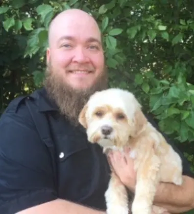 Chris holding a dog Chris holding a dog