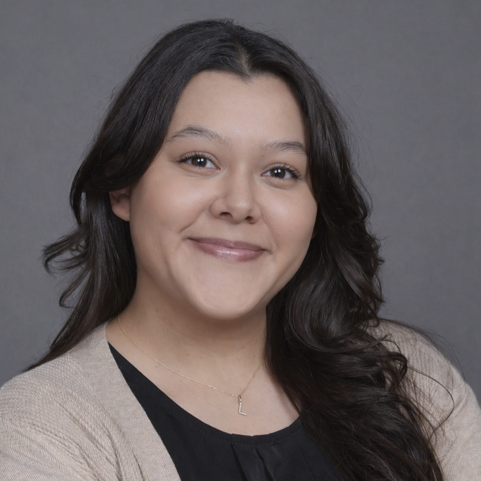 Letty Bonilla headshot in black shirt and beige cardigan sweater