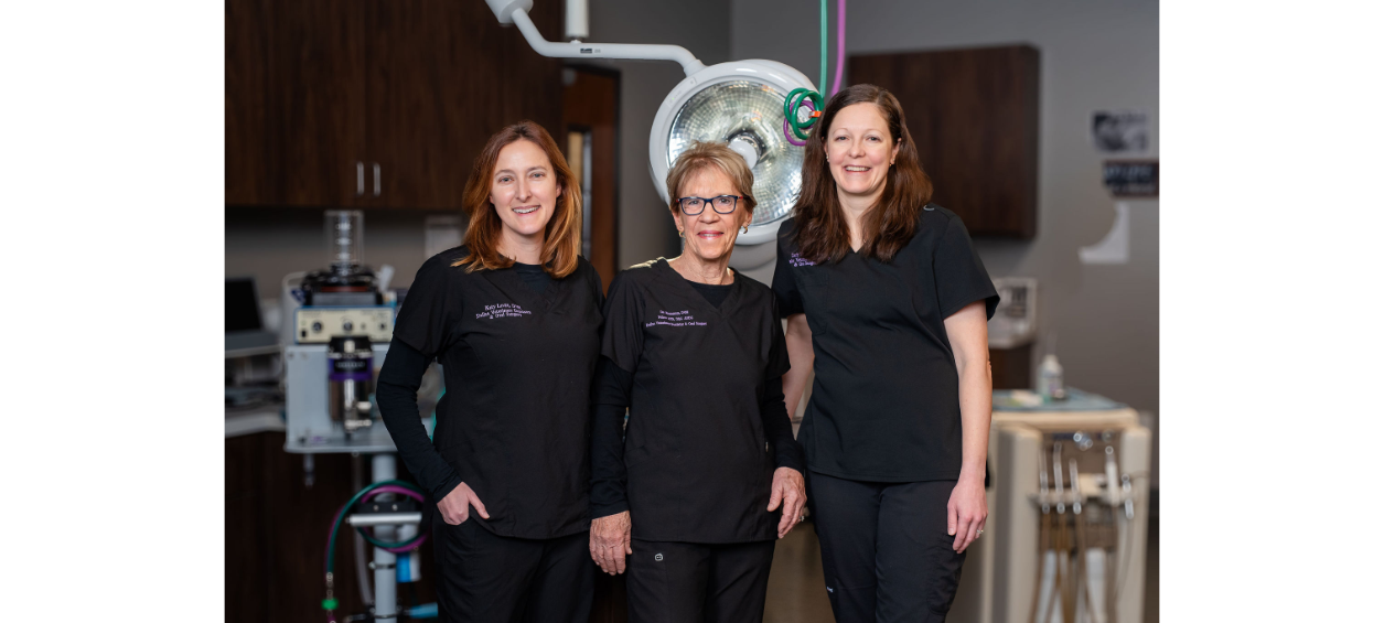 Three staff members smiling